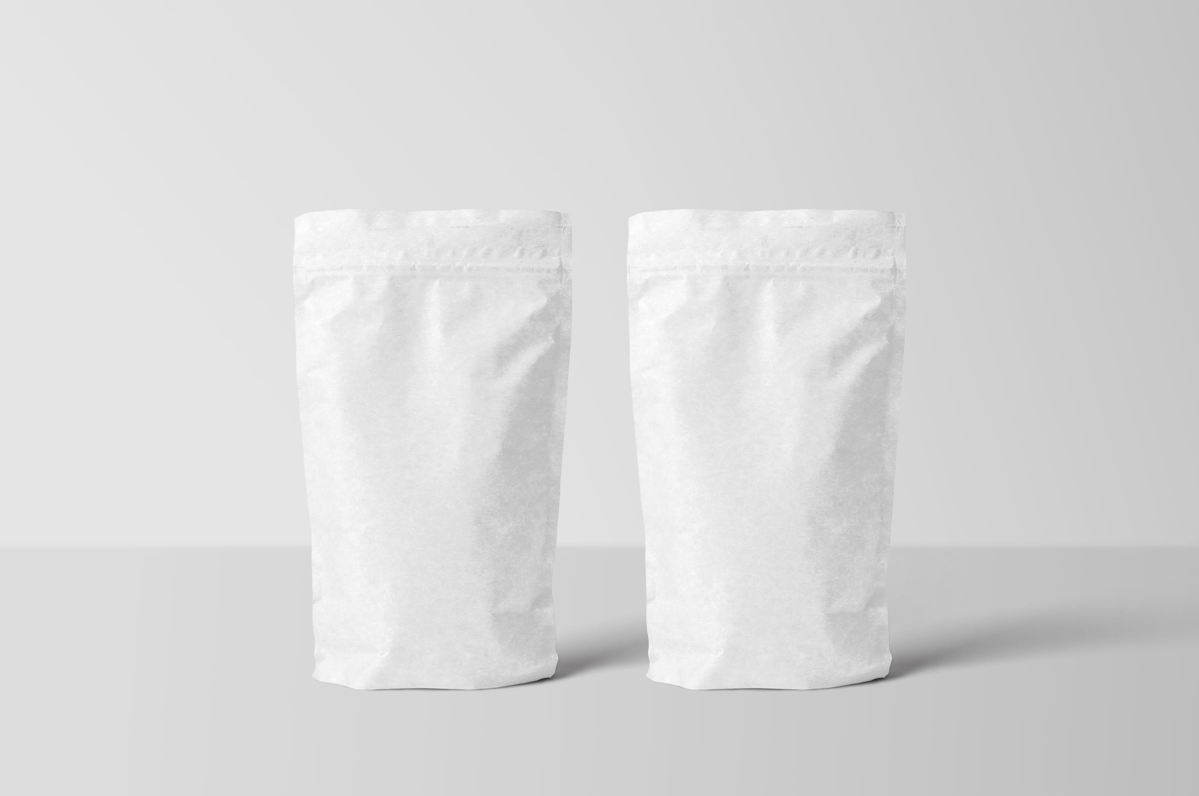Blank stand-up pouch bag mockups displayed on a clean surface for a custom mylar bag proof