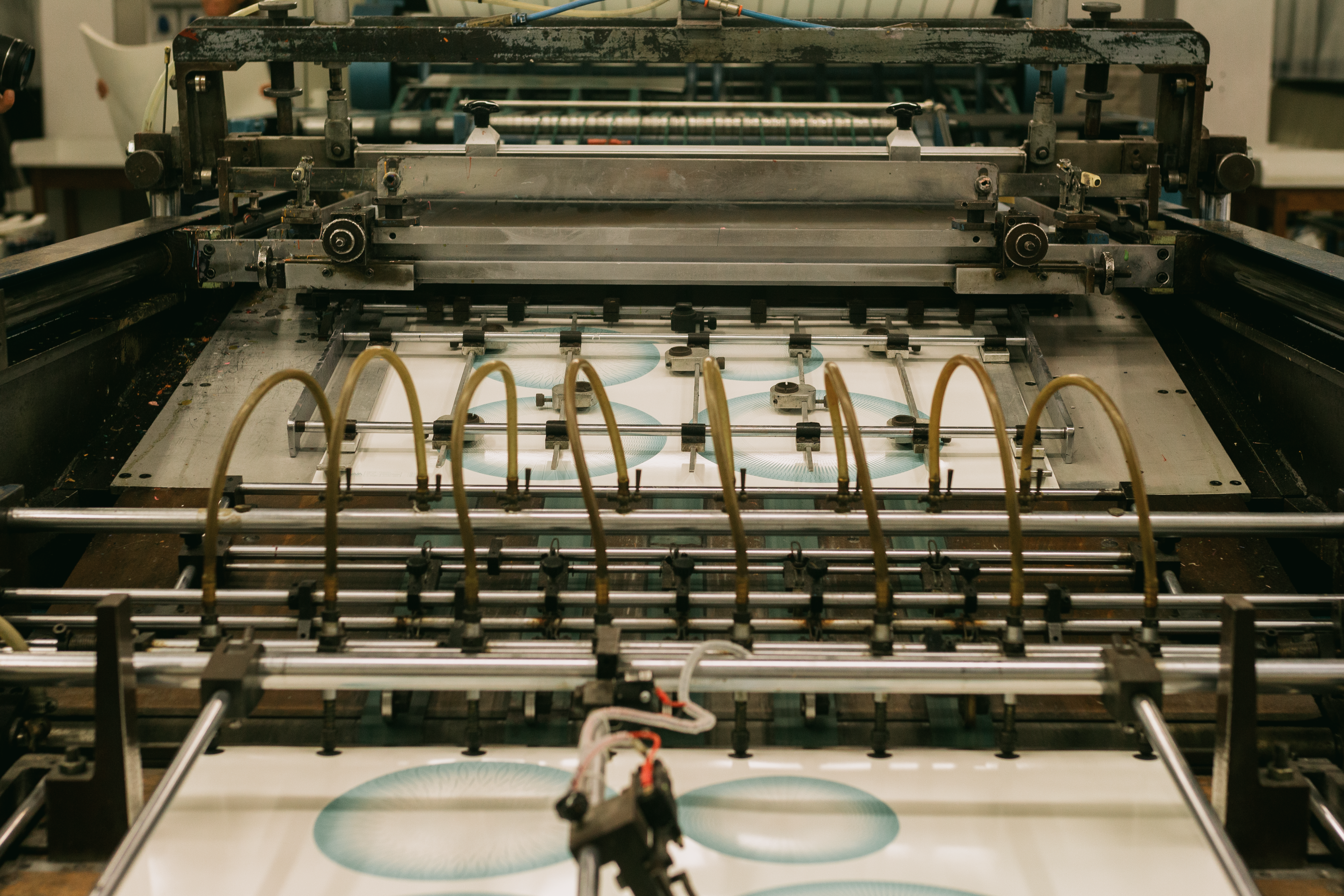 Close-up of an industrial printing press running a flexographic print job for packaging