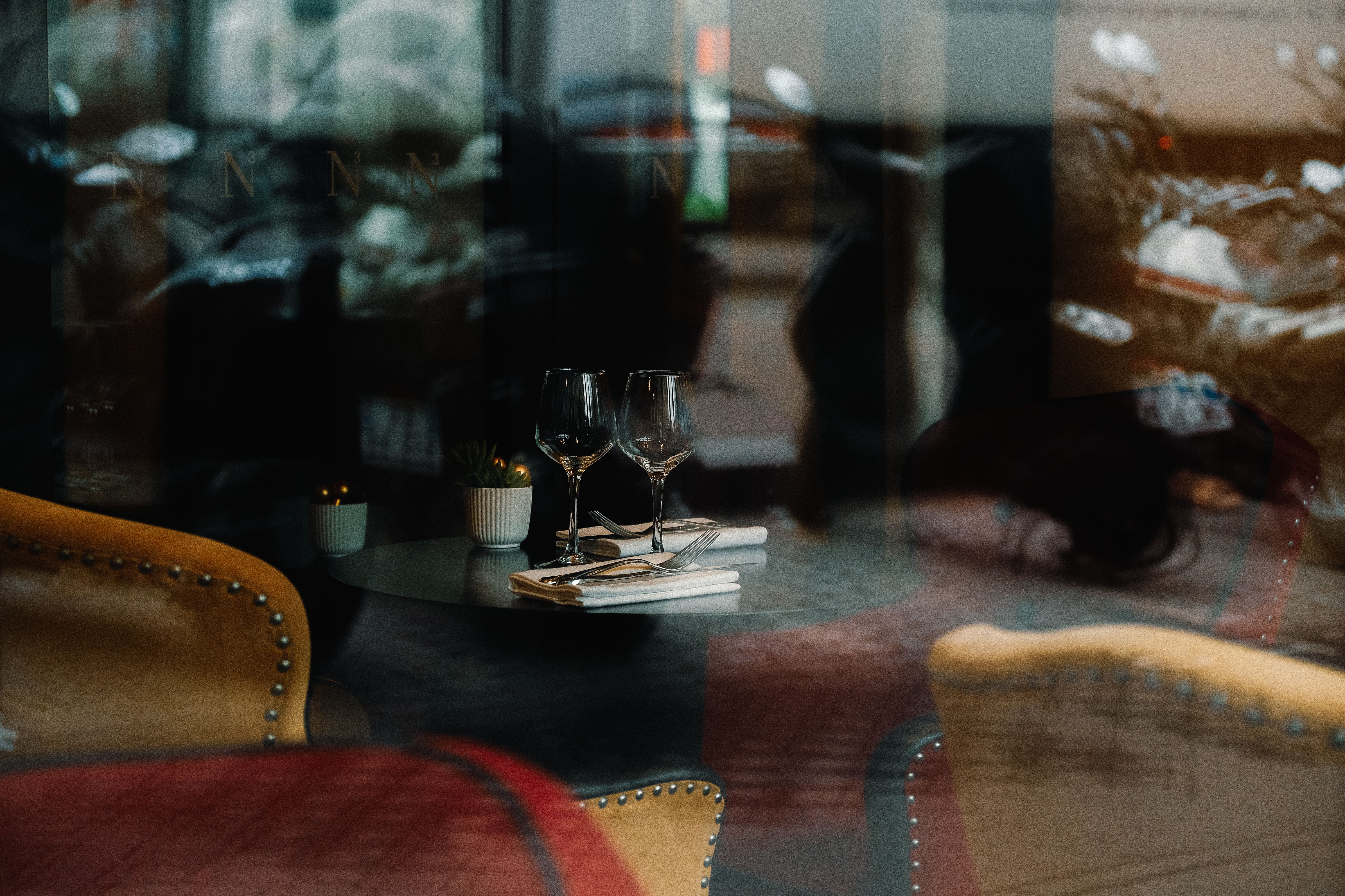 An intimate upscale restaurant dining room set for a quiet, private luxury experience.